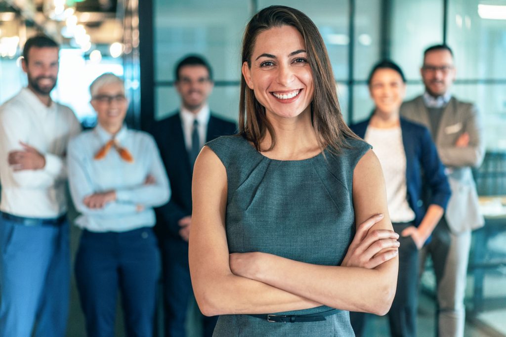 Woman Portrait with Team in Background