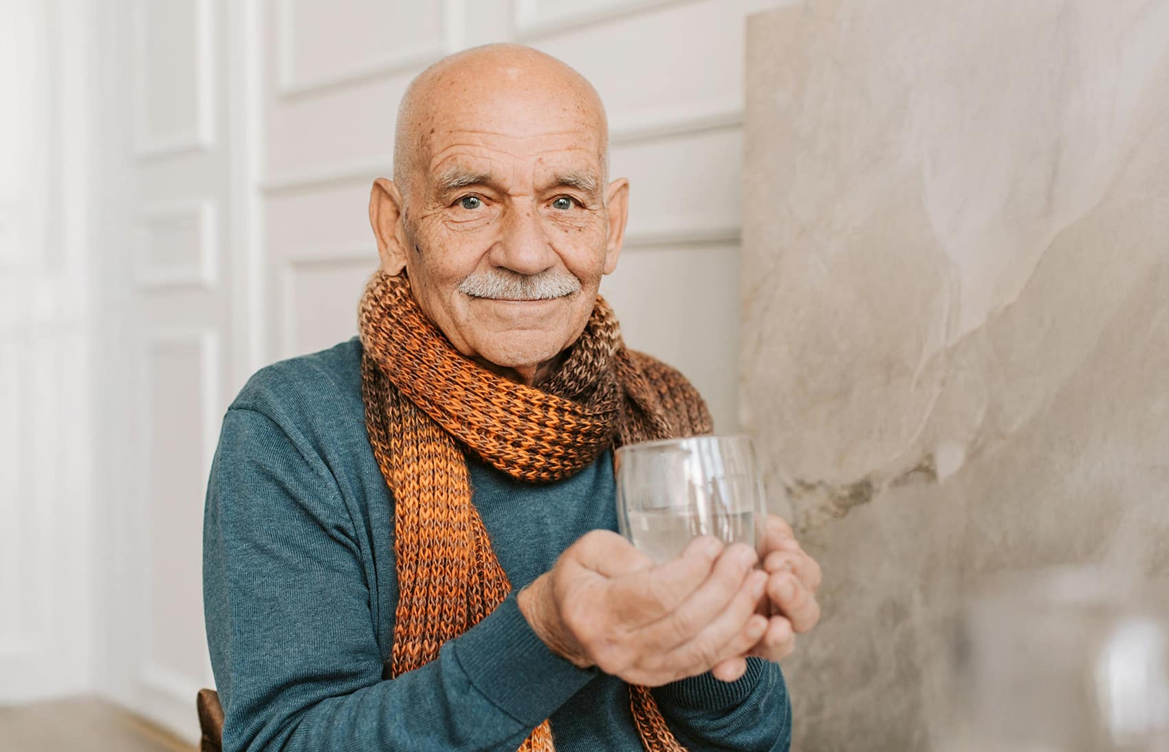 Elder Man with Bright Green Eyes Drinking Water